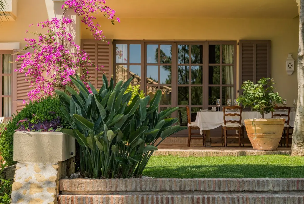 Traditional shaded terrace and mature gardens at an El Madroñal villa